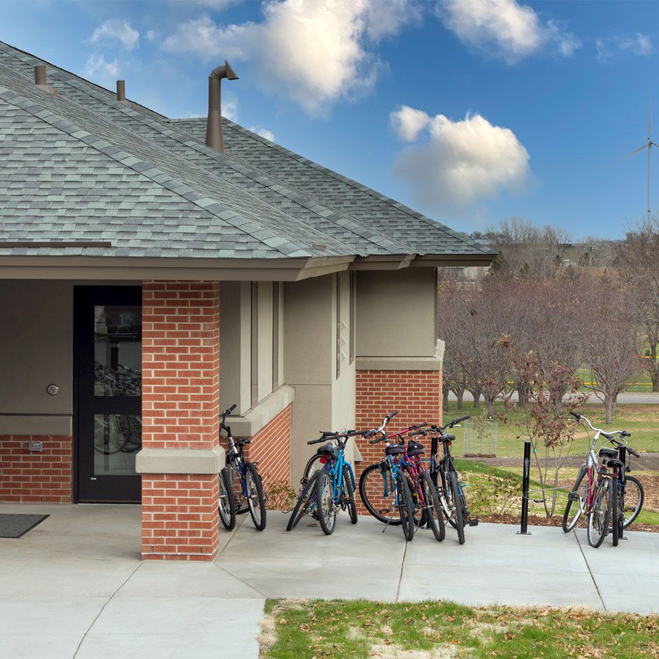 A single story brick building with bicycles parked next to it