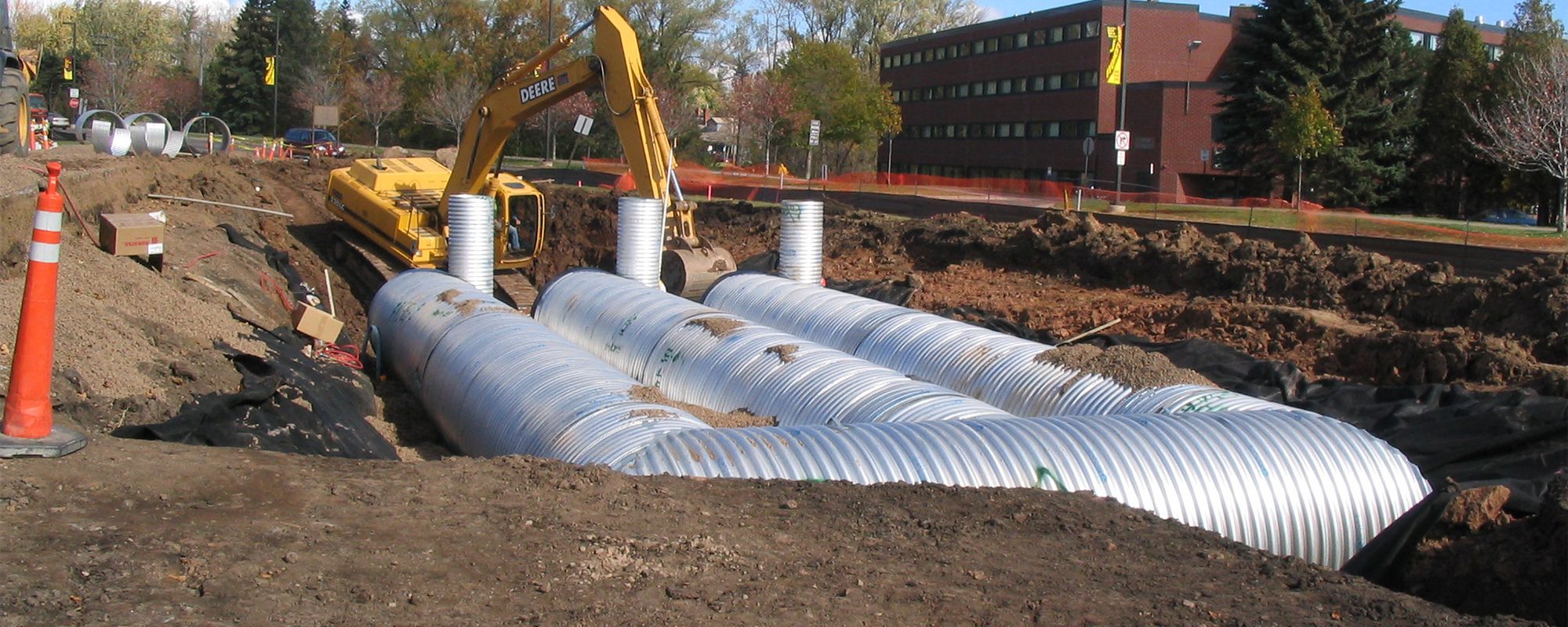 large utility infrastructure tubes being buried underground