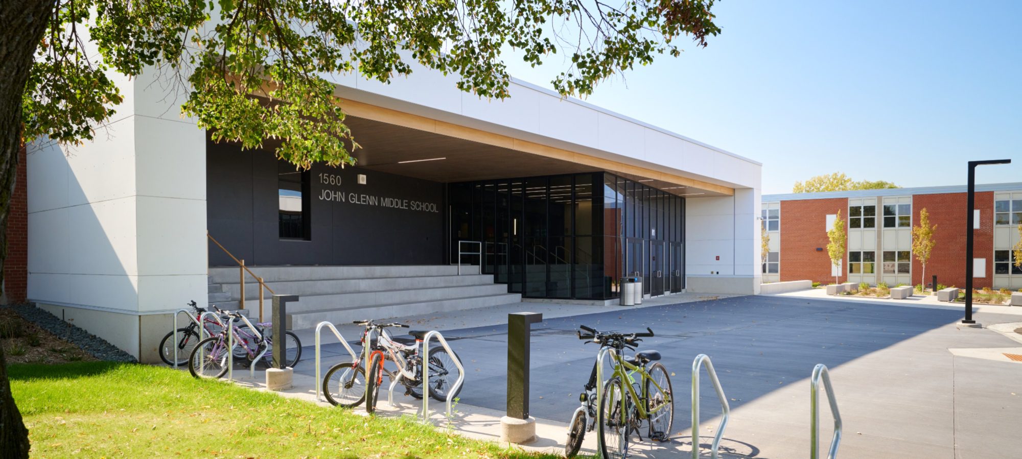Front entry to contemporary school with bikes and bike racks
