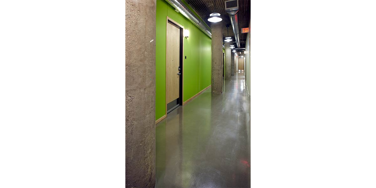 green hallway in renaissance box with entrance to unit