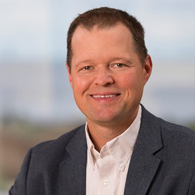 portrait of man in blue jacket and white shirt